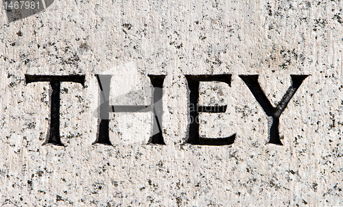 Image of Word "They" Carved in Gray Granite Stone