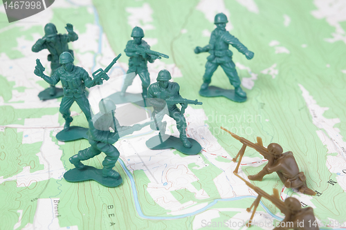 Image of Plastic Army Men Fighting on Topographic Map