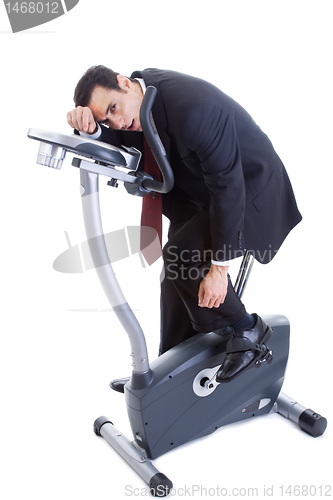 Image of Exhausted Businessman on Exercise Bike Isolated White Background
