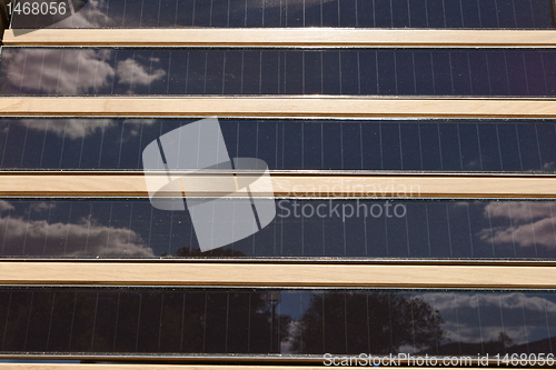 Image of Rows of Louvered Solar Panels, Reflection Sky Trees