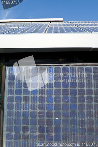 Image of Rows of PV Solar Panels Mounted on Roof Blue Sky 