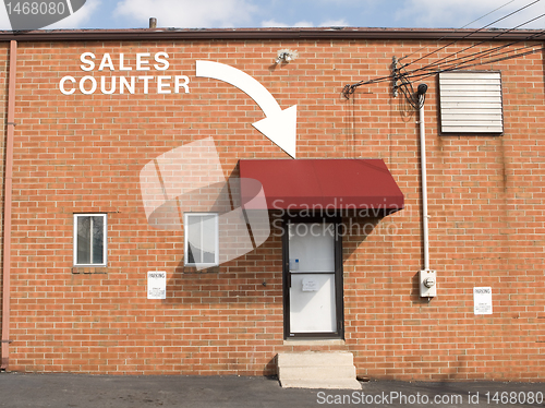 Image of Arrow and Words Brick Wall Point to Sales Counter