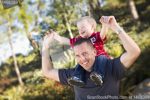 Image of Young Laughing Father and Child Piggy Back