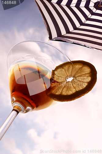 Image of Summer cocktail. Martini and beach umbrella