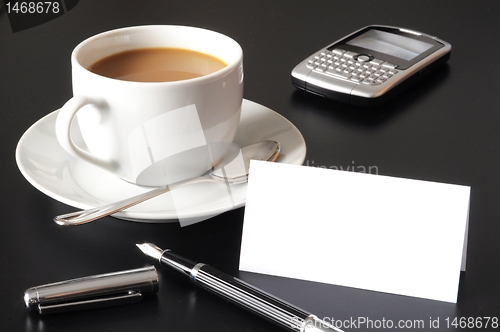Image of cup of coffee and paper copyspace