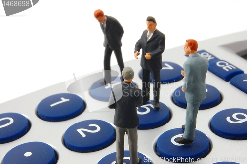 Image of business people on calculator isolated