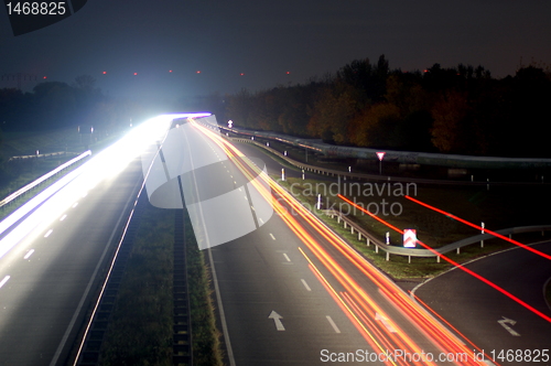 Image of road with car traffic at night with blurry lights