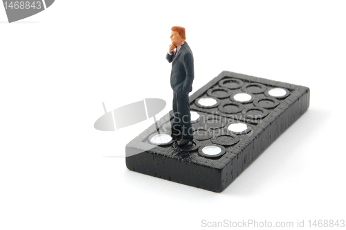 Image of business man on domino isolated