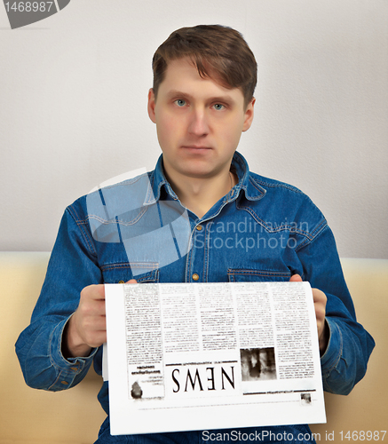 Image of Man reads newspaper