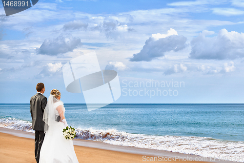 Image of Bride and groom on the beach