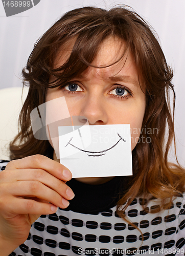 Image of Tired woman smiles as may