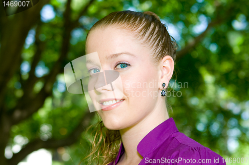 Image of Attractive Young Woman Head Shot Outside Trees