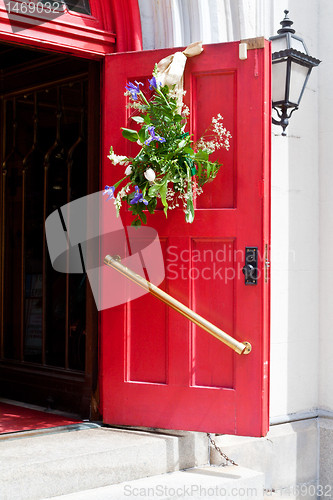 Image of Open Red Church Door with Easter Flowers Decorations