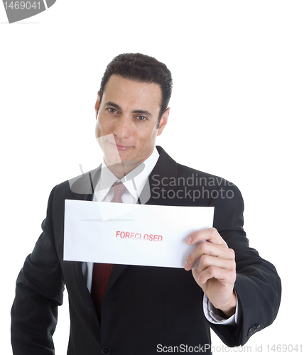 Image of Front Smug Businessman Holding Envelope Marked Foreclosed, Isola