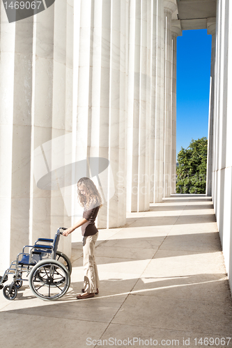 Image of Woman Lincoln Memorial Columns Empty Wheelchair DC
