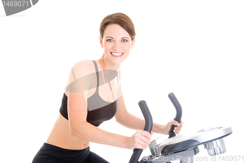 Image of Slender Caucasian Woman Riding Exercise Bike Isolated