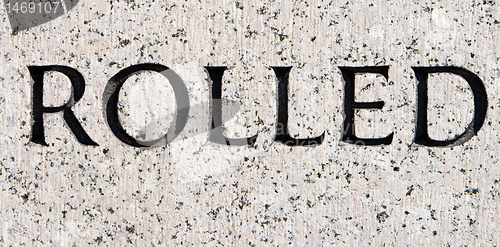 Image of Word "Rolled" Carved in Gray Granite Stone