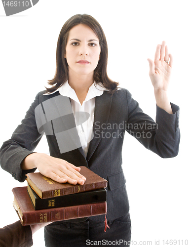 Image of Caucasian Woman Swearing on Stack of Bibles Isolated White Backg
