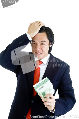 Image of Angry Asian Man Holding Crumpled Stock Certificate Hand on Head