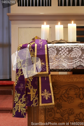 Image of Three burning candles on church altar