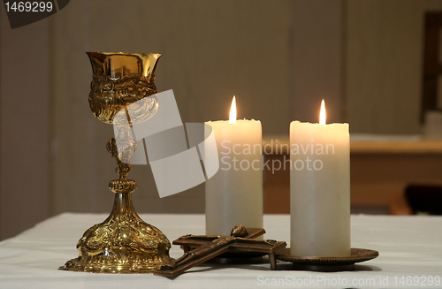 Image of Golden chalice and two burning candles
