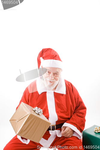 Image of Smiling Santa Holding Wrapped Package Isolated