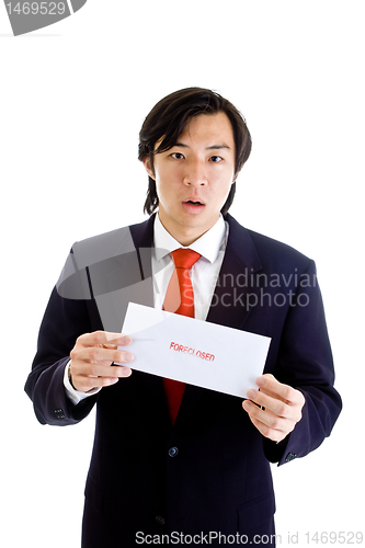 Image of Shocked Asian Man Holding Foreclosure Notice Isolated on White