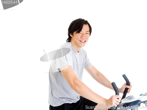 Image of Smiling Asian Man on Exercise Bike in Work Out Clothing