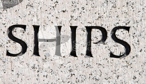 Image of Word "Ships" Carved in Gray Granite Stone Boats