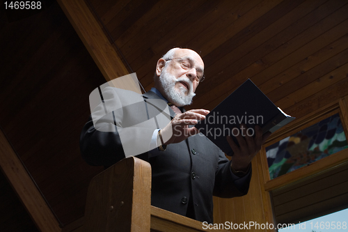 Image of Looking Up at Senior Man Singing Hymn Church Pew