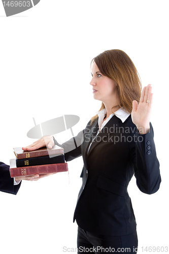 Image of Caucasian Businesswoman Swearing on a Stack of Bibles White Isol