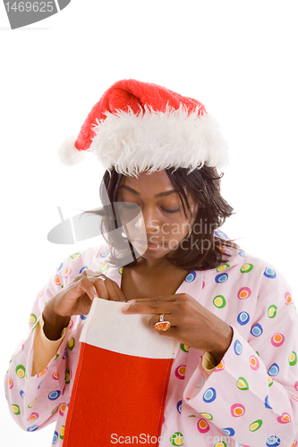 Image of Black Woman Looking Peeking Christmas Stocking