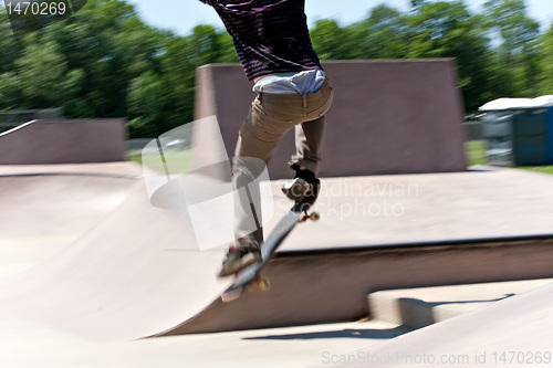 Image of Skater Jumping at the Concrete Skate Park