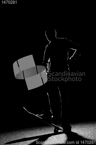 Image of Back Lit Skateboarder Silhouette