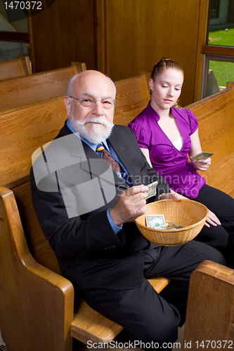 Image of Older Man Young Woman Donating Church Offering