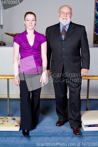 Image of White Senior Man and Young Woman Church Goers at Altar
