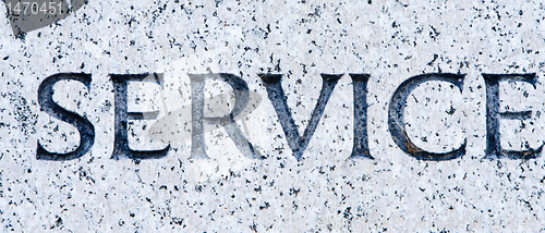 Image of Word "Service" Carved in Gray Granite Stone    