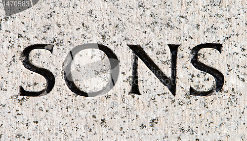 Image of Word "Sons" Carved in Gray Granite Stone