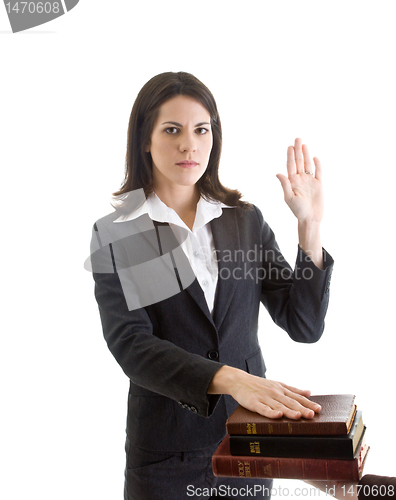 Image of White Woman Hand Raised Swearing Stack of Bibles