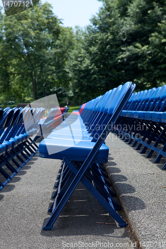 Image of XXXL Rows of Blue Red Metal Folding Chairs Outside