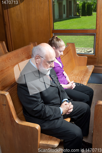 Image of Senior Man Young Woman Bowed Heads Praying Church