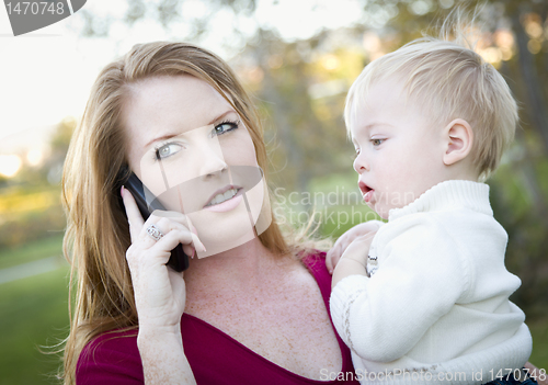 Image of Attractive Woman Using Cell Phone with Child