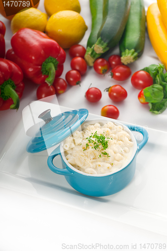 Image of mac and cheese on a blue little clay pot