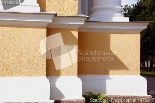 Image of Yellow building with white colums 