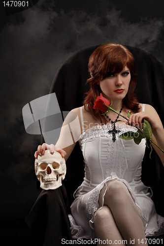 Image of Young sexy witch with a skull and rose