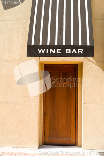 Image of Entrance to a Wine Bar, Awning, Wood, Stucco