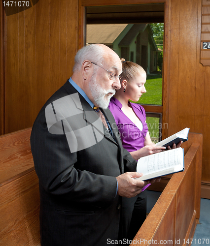 Image of Older Man Young Woman Standing in Church Singing Holding Hymnals