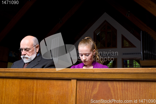Image of Senior Man Young Woman Sitting Head Bowed Praying Church Pew 