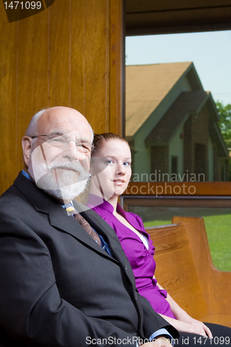 Image of Senior White Man Young Woman Sitting Church Pew