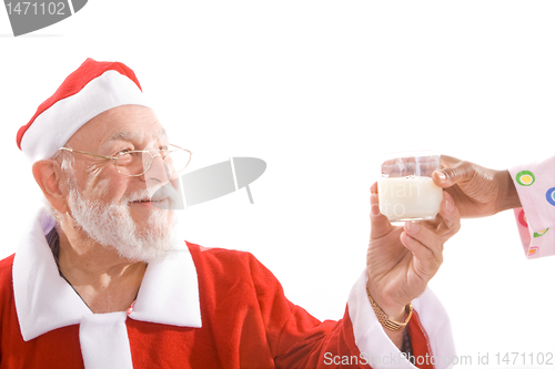 Image of Santa Taking Glass of Milk From Hand Isolated